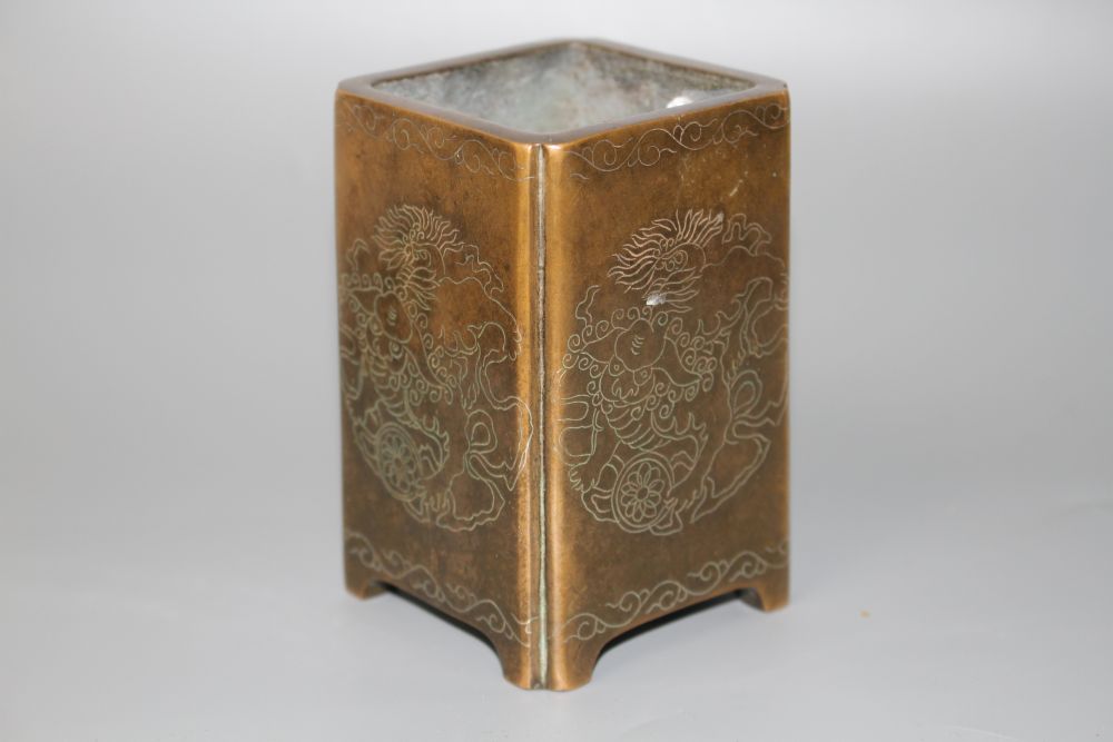 A Chinese bronze and silver inlaid square brush pot,